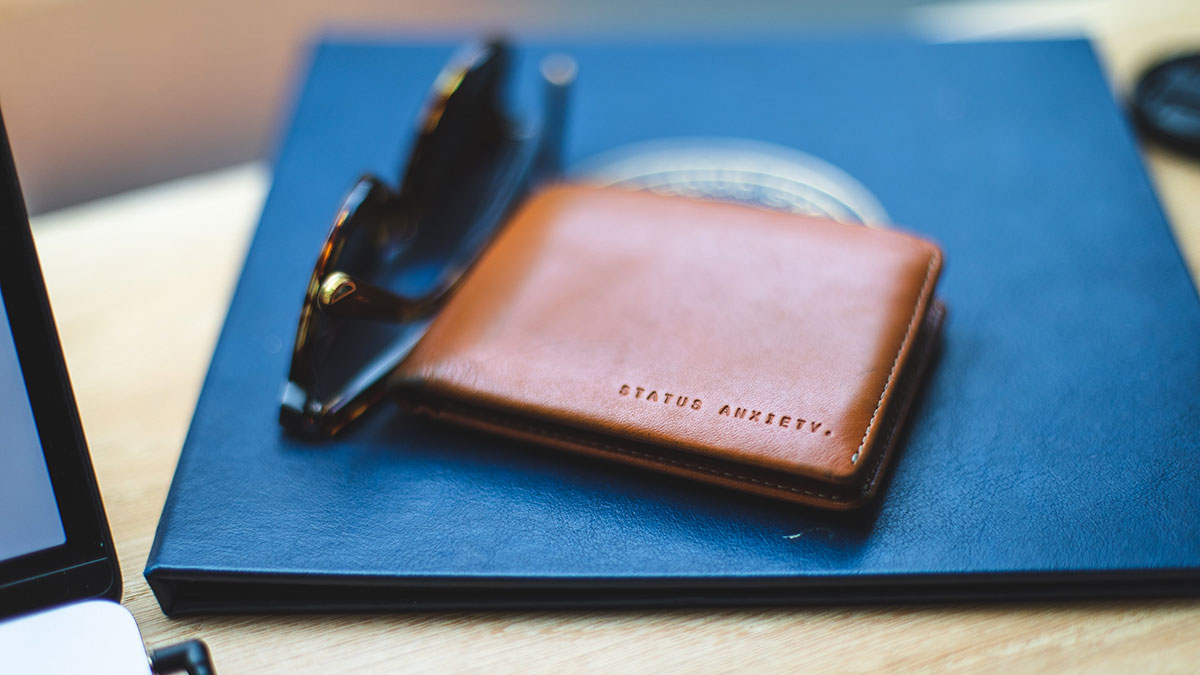 Wallet sitting on table next to sunglasses